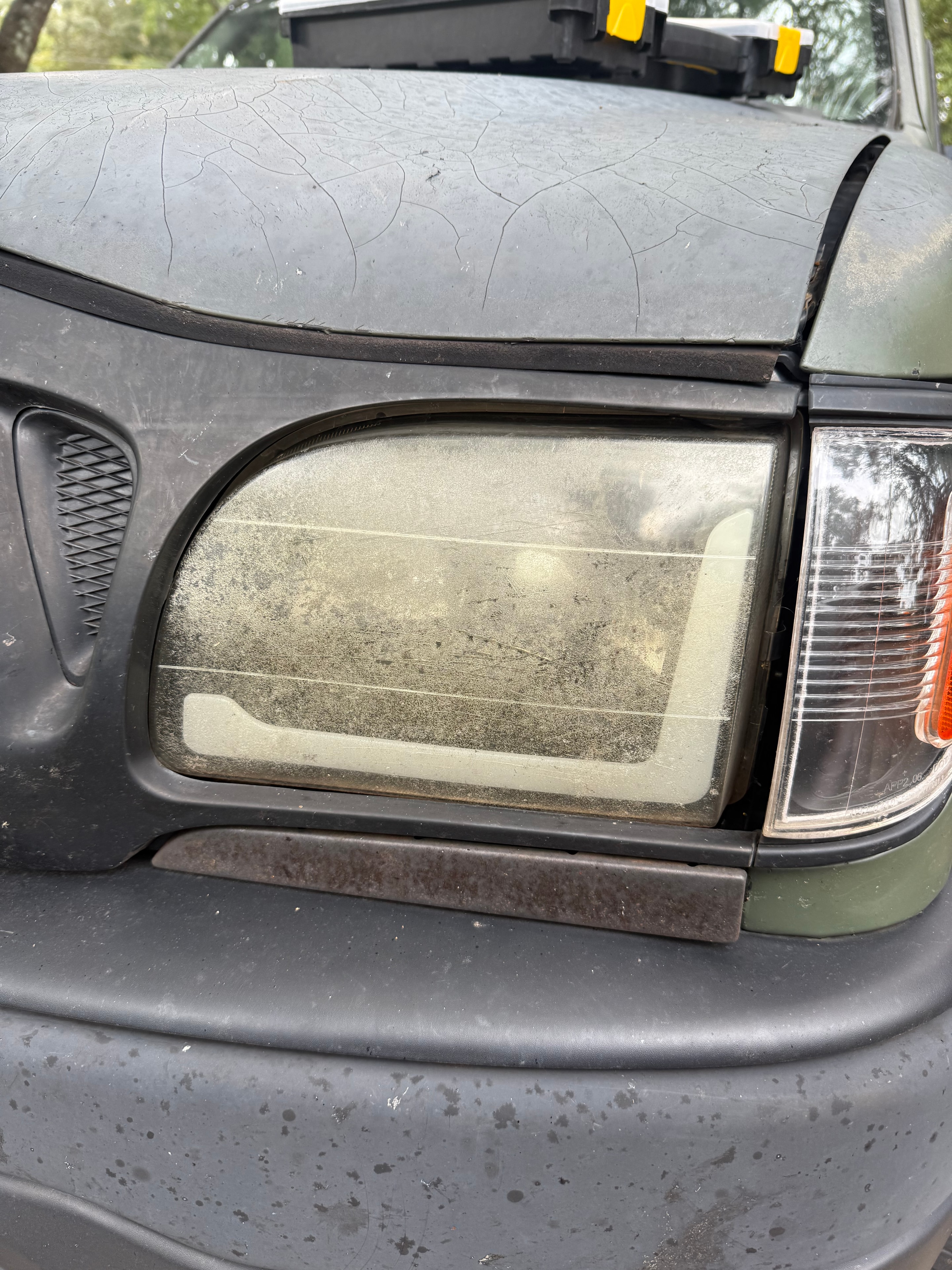 Dark truck headlight heavily oxidized before restoration