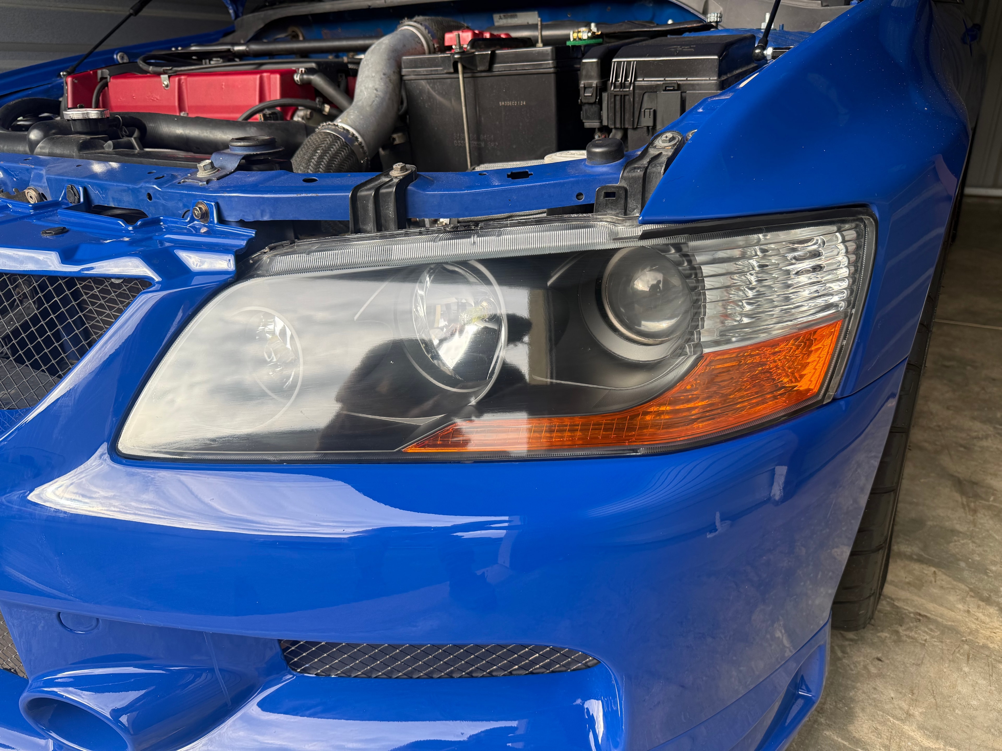 Blue Subaru with clean restored headlight after restoration